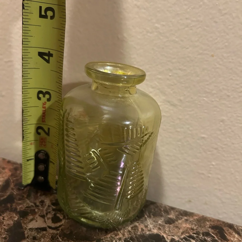 yellow iridescent glass vase with a leaf etching
